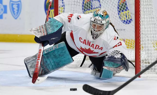 Canada goalie Kayle Osborne (82) dives for a loose puck during the first period of a Rivalry Series women's hockey game against the United States, Saturday, Nov. 8, 2025, in Buffalo, N.Y. (AP Photo/Adrian Kraus)