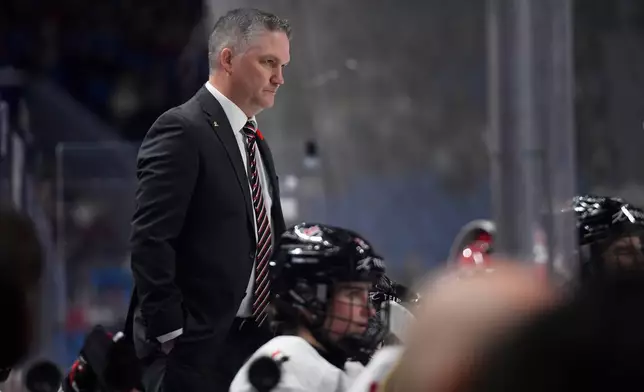 Canada head coach Troy Ryan watches play during the second period of a Rivalry Series women's hockey game against the United States, Saturday, Nov. 8, 2025, in Buffalo, N.Y. (AP Photo/Adrian Kraus)