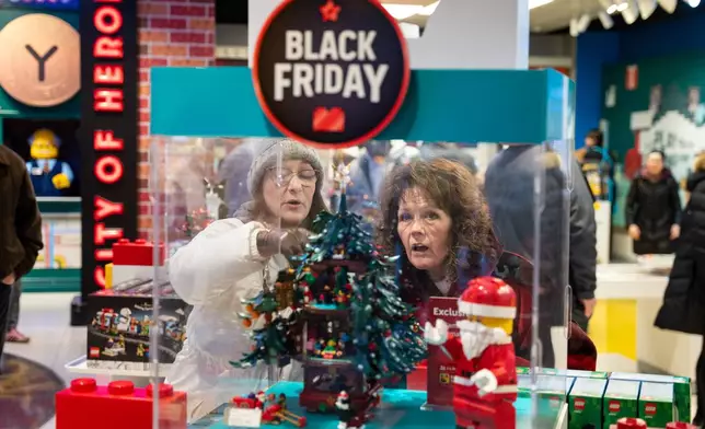 Black Friday shoppers admire a Christmas LEGO set at the LEGO flagship store in New York on Friday, Nov. 28, 2025. (AP Photo/Angelina Katsanis)