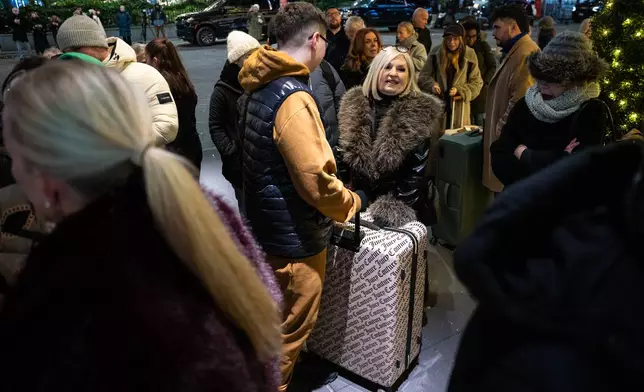 Black Friday Shoppers wait in line to enter Macy's flagship store on Friday, Nov. 28, 2025 in New York. (AP Photo/Angelina Katsanis)