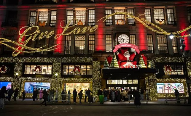 Black Friday Shoppers wait in line to enter Macy's flagship store on Friday, Nov. 28, 2025 in New York. (AP Photo/Angelina Katsanis)