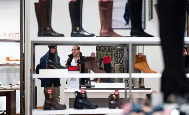 Black Friday Shoppers browse products at Macy's flagship store in New York on Friday, Nov. 28, 2025. (AP Photo/Angelina Katsanis)