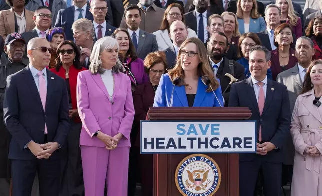 Rep. Sarah McBride, D-Del., center, joins House Minority Leader Hakeem Jeffries, D-N.Y., far left, and fellow Democrats as they advocate for improving the health care funding system, on the steps of the House before votes to end the government shutdown, at the Capitol in Washington, Wednesday, Nov. 12, 2025. (AP Photo/J. Scott Applewhite)