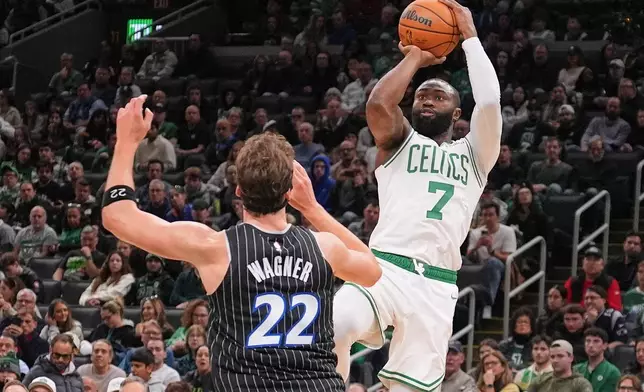 Boston Celtics guard Jaylen Brown (7) takes a shot over Orlando Magic forward Franz Wagner (22) during the first half of an NBA basketball game, Sunday, Nov. 23, 2025, in Boston. (AP Photo/Charles Krupa)