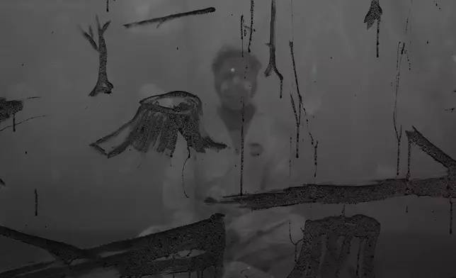 MUNDANO, a Brazilian artist, uses ashes collected from wildfires as he participates in a demonstration to raise awareness against forest destruction at the COP30 U.N. Climate Summit, Tuesday, Nov. 18, 2025, in Belem, Brazil. (AP Photo/Joshua A. Bickel)