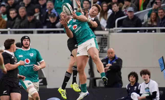 Ireland's James Lowe and New Zealand's Beauden Barrett compete for the ball during the rugby international between the All Blacks and Ireland in Chicago, Saturday, Nov. 1, 2025. (AP Photo/Erin Hooley)