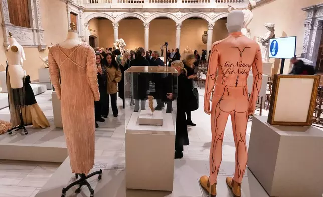 A spandex bodysuit by Belgian designer Walter Van Beirendonck from a 2009 collection, right, is displayed during the announcement, at the Metropolitan Museum of Art, in New York, Monday, Nov. 17, 2025, about the next spring fashion exhibit "Costume Art," which is set to launch at the Met Gala in 2026. (AP Photo/Richard Drew)