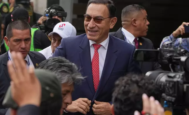 Former President Martin Vizcarra, who faces corruption charges, smiles as he arrives for a sentence hearing in Lima, Peru, Wednesday, Nov. 26, 2025. (AP Photo/Guadalupe Pardo)