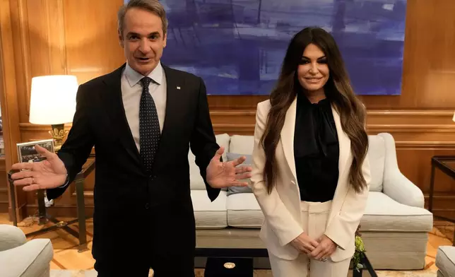 Greece's Prime Minister Kyriakos Mitsotakis, left, welcomes Kimberly Guilfoyle, the new U.S. Ambassador to Greece, at Maximos Mansion in Athens, Greece, Wednesday, Nov. 5, 2025. (AP Photo/Thanassis Stavrakis)