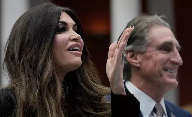 U.S. Interior Secretary Doug Burgum, Secretary, right, and U.S. Ambassador to Greece Kimberly Guilfoyle attend the Atlantic Council conference in Athens, Greece, Thursday, Nov. 6, 2025. (AP Photo/Thanassis Stavrakis)
