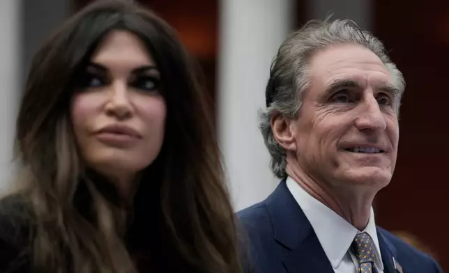 U.S. Interior Secretary Doug Burgum, Secretary, right, and U.S. Ambassador to Greece Kimberly Guilfoyle attend the Atlantic Council conference in Athens, Greece, Thursday, Nov. 6, 2025. (AP Photo/Thanassis Stavrakis)