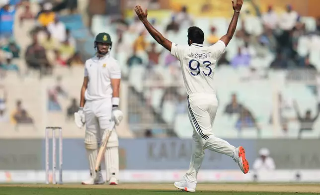 India's Jasprit Bumrah celebrates the dismissal of South Africa's Aiden Markram, left, on the first day of the first cricket test match between India and South Africa in Kolkata, India, Friday, Nov. 14, 2025. (AP Photo/Aijaz Rahi)