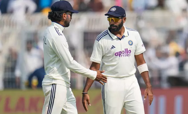 India's Jasprit Bumrah, right, and KL Rahul leave the field for lunch on the first day of the first cricket test match between India and South Africa in Kolkata, India, Friday, Nov. 14, 2025. (AP Photo/Aijaz Rahi)