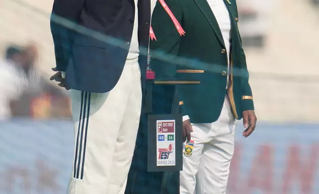 India's captain Shubman Gill, left, and South Africa's captain Temba Bavuma pose with the trophy before the start of of the first day of the first cricket test match between India and South Africa in Kolkata, India, Friday, Nov. 14, 2025. (AP Photo/Aijaz Rahi)