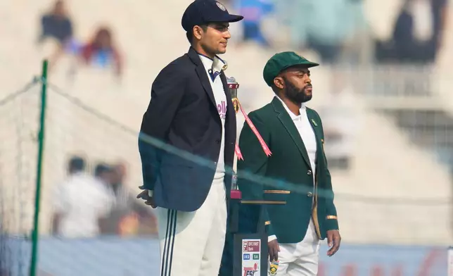 India's captain Shubman Gill, left, and South Africa's captain Temba Bavuma pose with the trophy before the start of of the first day of the first cricket test match between India and South Africa in Kolkata, India, Friday, Nov. 14, 2025. (AP Photo/Aijaz Rahi)