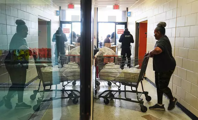 Volunteer Karen Robinson moves groceries durning an emergency food distribution at The Jewish Federation of Greater Philadelphia's Mitzvah Food Program in Philadelphia, Friday, Nov. 7, 2025. (AP Photo/Matt Rourke)