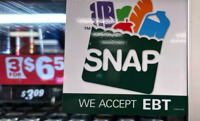 FILE - SNAP EBT information sign is displayed at a gas station in Riverwoods, Ill., Saturday, Nov. 1, 2025. (AP Photo/Nam Y. Huh, file)