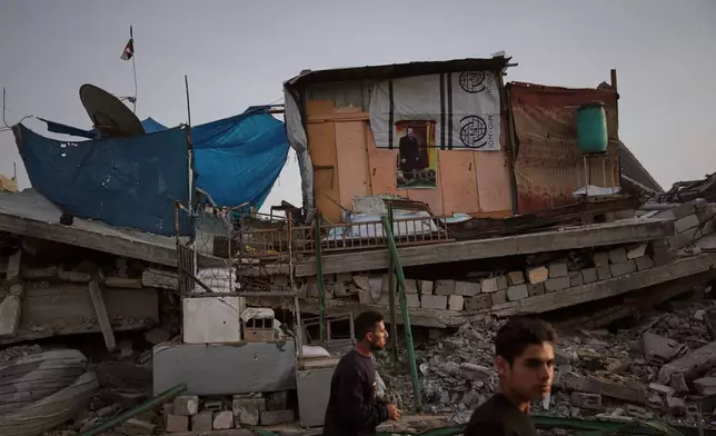 A tent sheltering displaced Palestinians stands atop rubble left by Israeli air and ground operations in Gaza City Saturday, Nov. 29, 2025. (AP Photo/Abdel Kareem Hana)