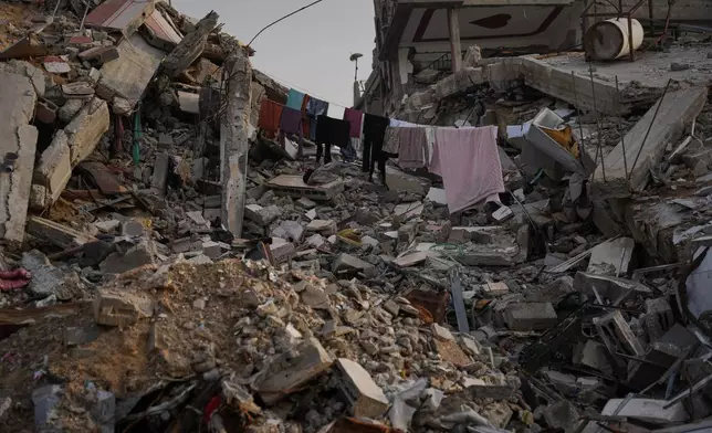 Laundry hangs between the rubble left by Israeli air and ground offensive in Gaza City, Saturday, Nov. 29, 2025. (AP Photo/Abdel Kareem Hana)
