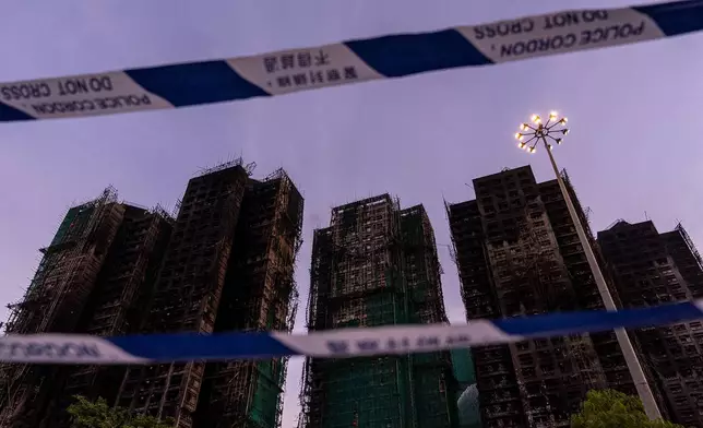 Burned buildings are seen at the scene of the fire at Wang Fuk Court, a residential estate in the Tai Po district of Hong Kong's New Territories, Friday, Nov. 28 2025. (AP Photo/Chan Long Hei)