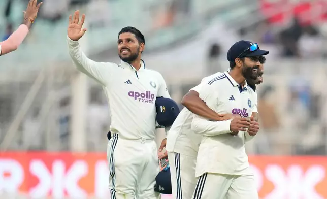 India's Ravindra Jadeja, front, celebrates with teammate Mohammed Siraj at the end of play on the second day of the first cricket test match between India and South Africa in Kolkata, India, Saturday, Nov. 15, 2025. (AP Photo/Aijaz Rahi)