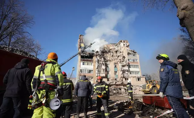 Rescue workers put out a fire of a residential building which was damaged by a Russian strike on Ternopil, Ukraine, on Wednesday, Nov. 19, 2025. (AP Photo/Rostyslav Kovalchuk)