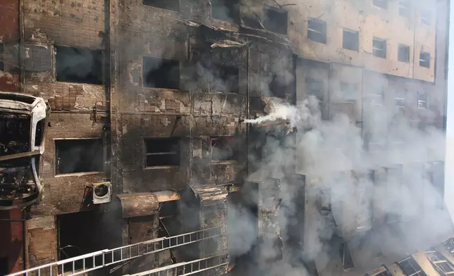 Smoke rises from a residential building which was heavily damaged after a Russian strike on Ternopil, Ukraine, on Wednesday, Nov. 19, 2025. (AP Photo/Vlad Kravchuk)
