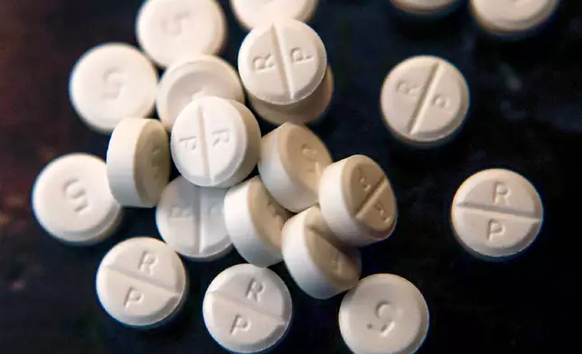 FILE - Several 5-mg pills of Oxycodone are seen June 17, 2019, in Zelienople, Pa. (AP Photo/Keith Srakocic, File)