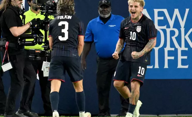 United States' John Tonkin (3) and Diego Luna (10) celebrate Luna's goal during the first half of an international friendly soccer game against Uruguay, Tuesday, Nov. 18, 2025, in Tampa, Fla. (AP Photo/Jason Behnken)