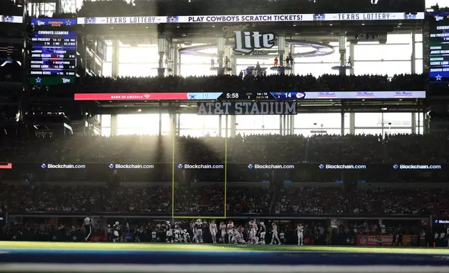 Light streams through a window and onto the field inside AT&amp;T Stadium during the first half of an NFL football game between the Kansas City Chiefs and the Dallas Cowboys Thursday, Nov. 27, 2025, in Arlington, Texas. (AP Photo/Gareth Patterson)
