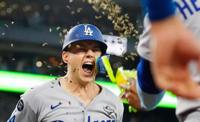 Los Angeles Dodgers' Will Smith (16) celebrates after hitting a solo home run against the Toronto Blue Jays during the 11th inning in Game 7 of baseball's World Series against the Toronto Blue Jays in Toronto on Sunday, Nov. 2, 2025. (Frank Gunn/The Canadian Press via AP)