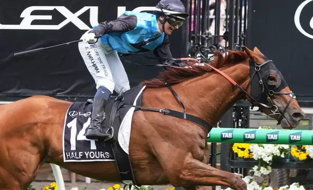 Jamie Melham rides Half Yours to win the Melbourne Cup horse race in Melbourne, Australia, Tuesday, Nov. 4, 2025. (AP Photo/Asanka Brendon Ratnayake)
