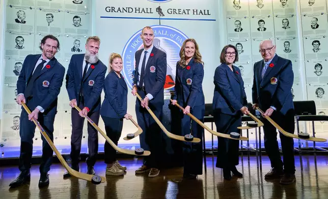 Hockey Hall of Fame inductees, from left, Duncan Keith, Joe Thornton, Brianna Decker, Zdeno Chara, Jennifer Botterill, Danièle Sauvageau and Jack Parker pose for a photograph in Toronto, Saturday, Nov. 8, 2025. (Sammy Kogan/The Canadian Press via AP)