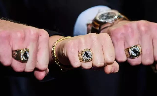 Hockey Hall of Fame inductees, from left, Joe Thornton, Brianna Decker and Zdeno Chara show off their rings in Toronto on Saturday, Nov. 8, 2025. (Sammy Kogan/The Canadian Press via AP)