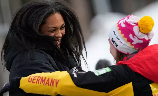 Winner Kaysha Love of the United States, left, celebrates with second placed Laura Nolte of Germany during the women's monobob race at the Bobsleigh World Cup in Innsbruck, Austria, Saturday, Nov. 29, 2025. (AP Photo/Matthias Schrader)