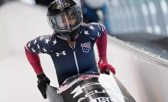 Winner Kaysha Love of the United States celebrates after the women's monobob race at the Bobsleigh World Cup in Innsbruck, Austria, Saturday, Nov. 29, 2025. (AP Photo/Matthias Schrader)