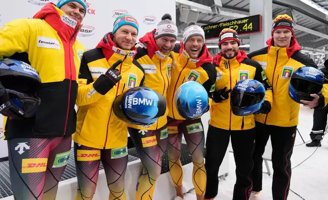 Winner Johannes Lochner and Georg Fleischhauer, second placed Francesco Friedrich and Alexander Schaller and third placed Adam Ammour and Tim Becker of Germany celebrate after the 2-man bobsleigh, at the Bobsleigh World Cup in Innsbruck, Austria, Saturday, Nov. 29, 2025. (AP Photo/Matthias Schrader)