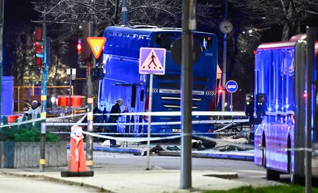 A double-decker bus crashed into a bus shelter in Stockholm on Friday, Nov. 14, 2025, causing fatalities and injuries. (Claudio Bresciani/TT News Agency via AP)