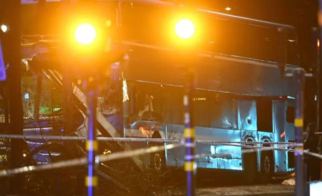 A double-decker bus crashed into a bus shelter in Stockholm on Friday, Nov. 14, 2025, causing fatalities and injuries. (Henrik Montgomery/TT News Agency via AP)