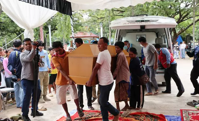 In this photo released by Agence Kampuchea Press (AKP), local residents carry a coffin with the body of Dy Nay body caused by Thai soldiers opened fire on civilians in Prey Chan village, Banteay Meanchey province, on the border with Thailand, at Prey Chan village, Banteay Meanchey province, Cambodia, Thursday, Nov. 13, 2025 (AKP via AP)