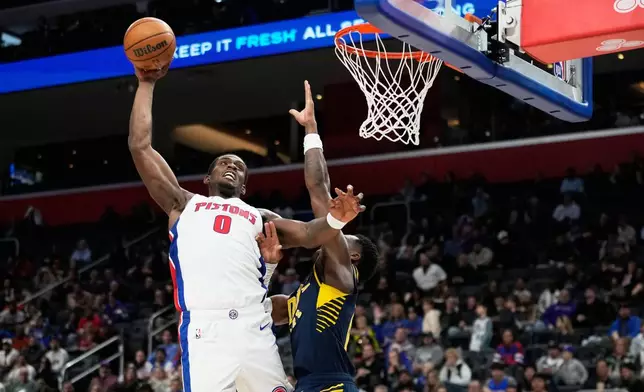 Detroit Pistons center Jalen Duren, left, dunks the ball against Indiana Pacers guard Bennedict Mathurin during the first half of an NBA basketball game, Monday, Nov. 17, 2025, in Detroit. (AP Photo/Ryan Sun)
