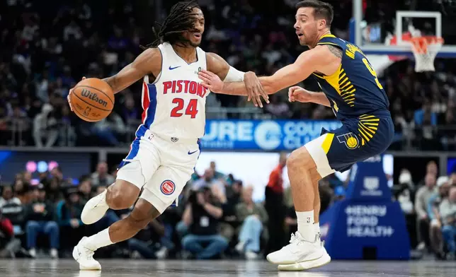 Detroit Pistons guard Daniss Jenkins, left, drives against Indiana Pacers guard T.J. McConnell during the first half of an NBA basketball game, Monday, Nov. 17, 2025, in Detroit. (AP Photo/Ryan Sun)