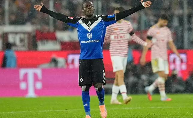 Hamburg's Jean-Luc Dompe celebrates after scoring his side's opening goal during the German Bundesliga soccer match between Cologne and Hamburger SV, in Cologne, Germany, Sunday, Nov. 2, 2025. (AP Photo/Martin Meissner)