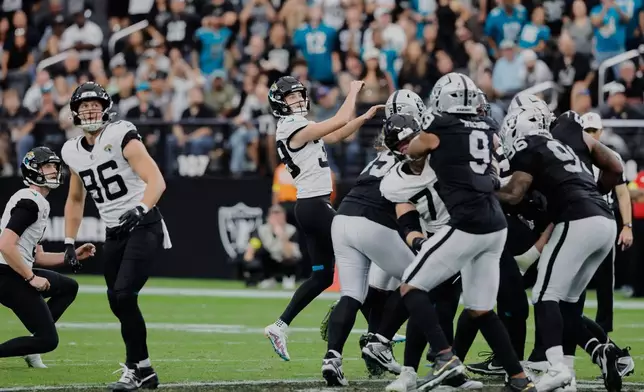 Jacksonville Jaguars place kicker Cam Little (39) watches his 68-yard field goal during the first half of an NFL football game against the Las Vegas Raiders, Sunday, Nov. 2, 2025, in Las Vegas. (AP Photo/Steve Marcus)