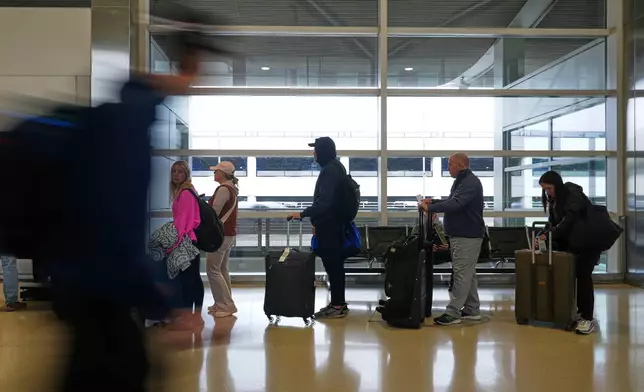 Travelers wait in lines at the Detroit Metropolitan Airport, Sunday, Nov. 9, 2025, in Detroit. (AP Photo/Ryan Sun)