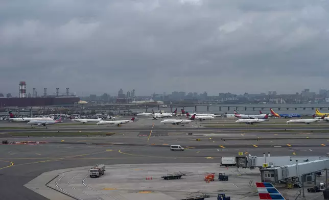 A group of planes wait in line for take off at LaGuardia Airport (LGA), in the Queens borough of New York, Sunday, Nov. 9, 2025. (AP Photo/Adam Gray)