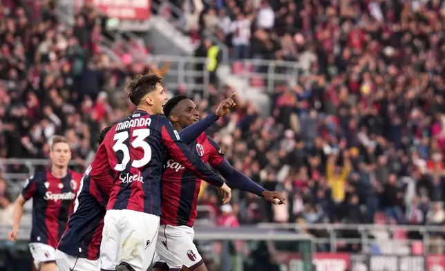 Bologna's Jhon Lucumi, right, celebrates after scoring his side's second goal during a Serie A soccer match between Bologna and Napoli, in Bologna, northern Italy, Sunday, Nov. 9, 2025. (Massimo Paolone/LaPresse via AP)