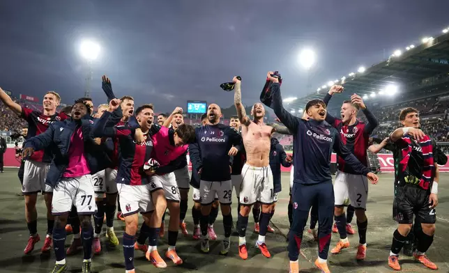 Bologna's players celebrate their 2-0 win at the end of a Serie A soccer match between Bologna and Napoli, in Bologna, northern Italy, Sunday, Nov. 9, 2025. (Massimo Paolone/LaPresse via AP)