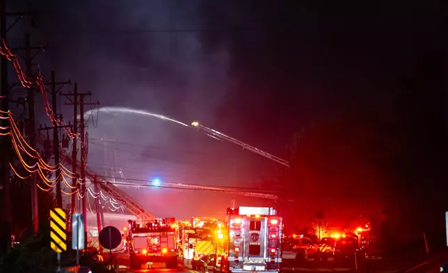 Plumes of smoke rise from the area of a plane crash at Louisville Muhammad Ali International Airport on Tuesday, Nov. 4, 2025, in Louisville, Ky. (AP Photo/Jon Cherry)