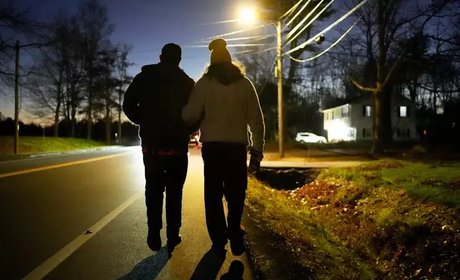 Graham Platner, Democratic candidate for U.S. Senate, and his wife, Amy Gertner, walk together while canvassing for a citizen's initiate on Election Day, Tuesday, Nov. 4, 2025, in Ellsworth, Maine. (AP Photo/Robert F. Bukaty)
